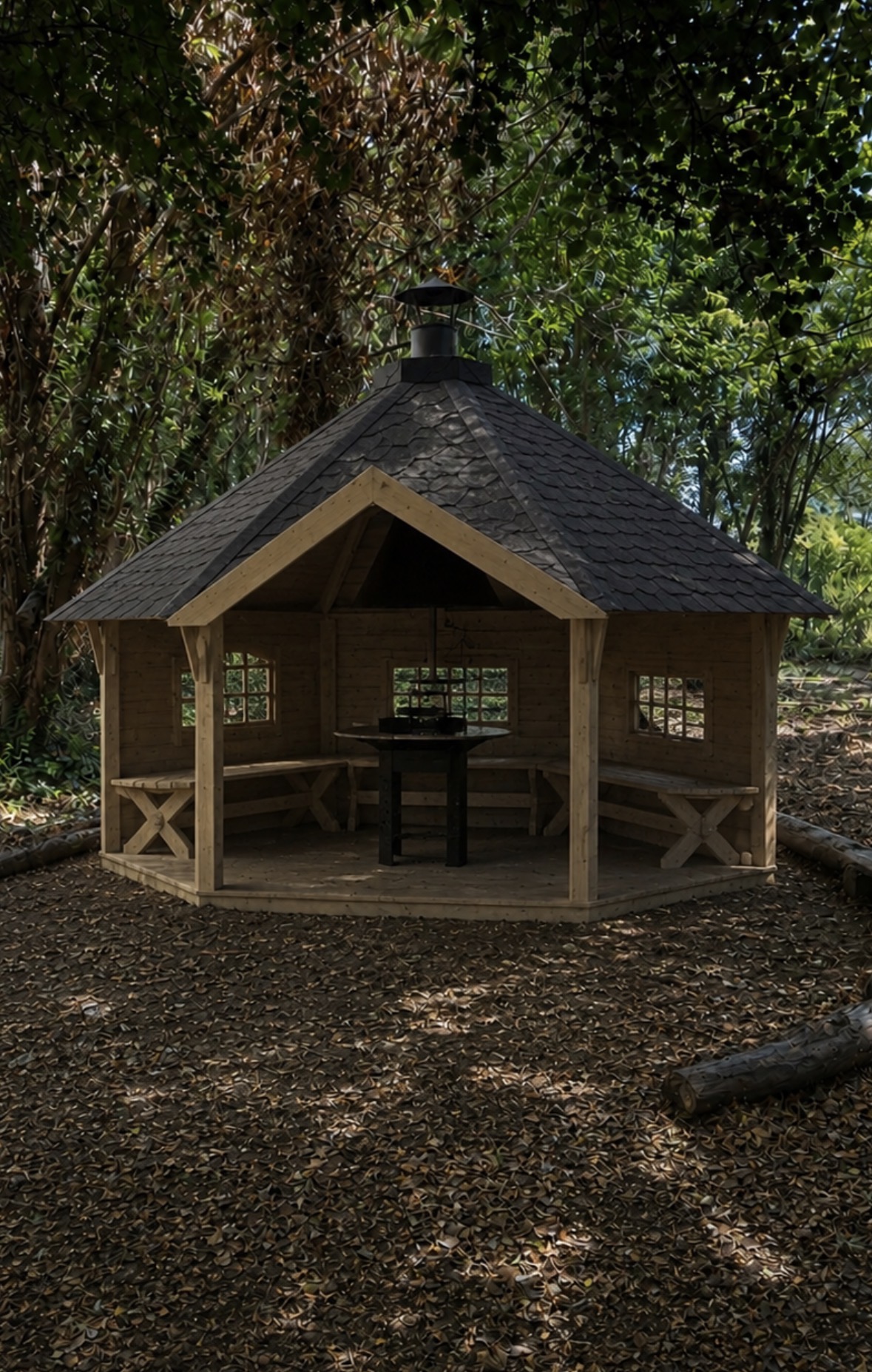 A drawing of a timber shelter in woodland with bench seating around a central fire and cooking table